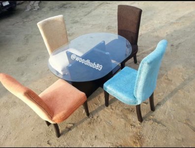 Four seater unconventional dinning set with a durable glass table top.
